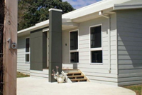 Image of the front of the cowes retreat holiday house showing front door and front decking.