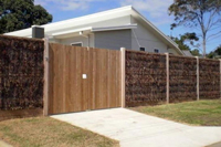 Front of the cowes retreat holiday house showing privacy fencing around front of property.