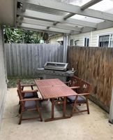Cowes retreat courtyard with barbeque and outdoor setting for enjoying the weather.
