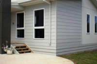 Front of the cowes retreat holiday house showing privacy fencing around front of property.