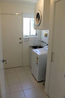 Laundry with washing machine and trough to wash the beach wear after a day surfing or enjoying the sand.