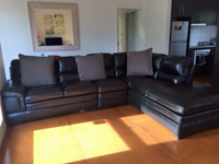 Spacious lounge room with modular lounge and tv ready for relaxing.